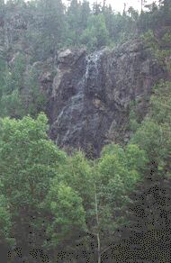 A waterfall flowing from the palisades.